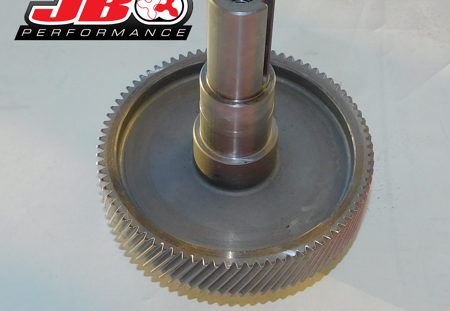 Metal gear with JB Performance logo.