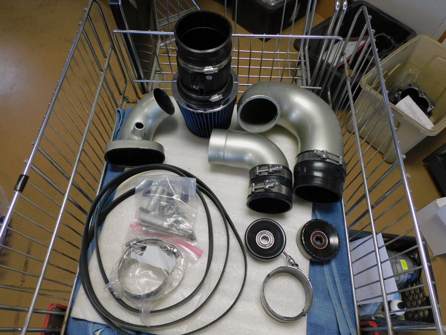 Car engine parts in a shopping cart.